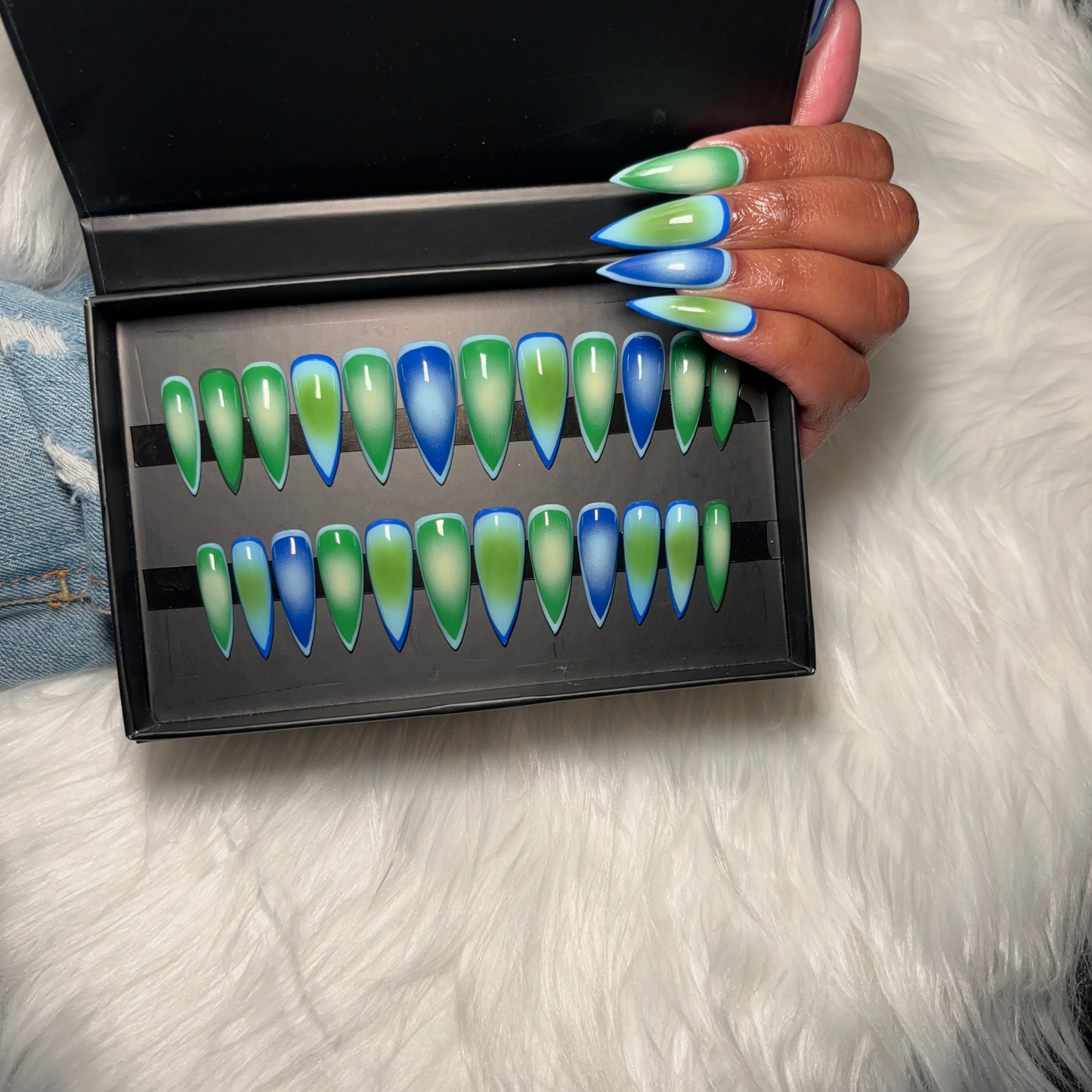 Aura airbrush press-on nails featuring a seamless gradient blend of green, sky blue, and light green tones. Designed for a soft, modern aesthetic with a high-gloss finish. Hand-painted on 100% Gel X tips for a salon-quality, reusable finish. Available in Square, Stiletto, Ballerina, and Coffin shapes