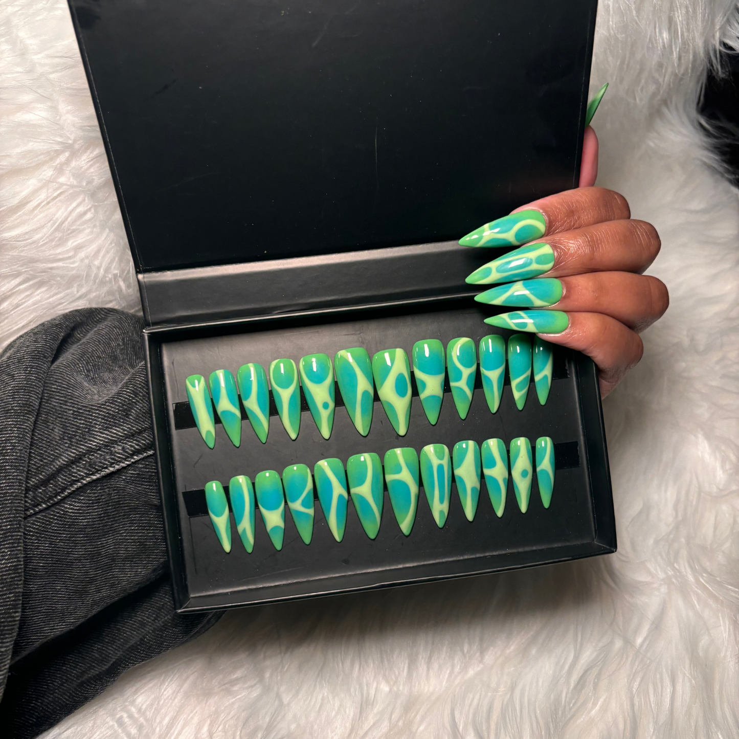 Green airbrush stiletto nails, turquoise blue aura stiletto nails, long gel press-ons, trendy handmade press-on nails, trendy nail design, reusable press-ons, bold nail designs, airbrush nails, high-quality stiletto press-ons, salon-quality aura nails, designed press-on nails, fashionable long press-on