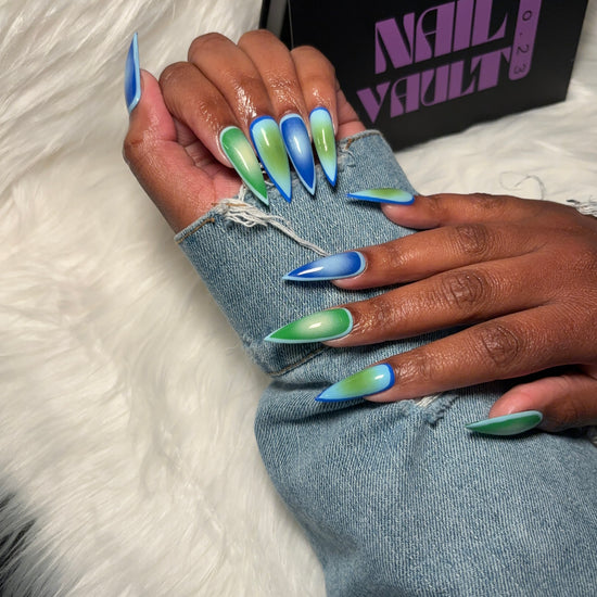 Aura airbrush press-on nails featuring a seamless gradient blend of green, sky blue, and light green tones. Designed for a soft, modern aesthetic with a high-gloss finish. Hand-painted on 100% Gel X tips for a salon-quality, reusable finish. Available in Square, Stiletto, Ballerina, and Coffin shapes