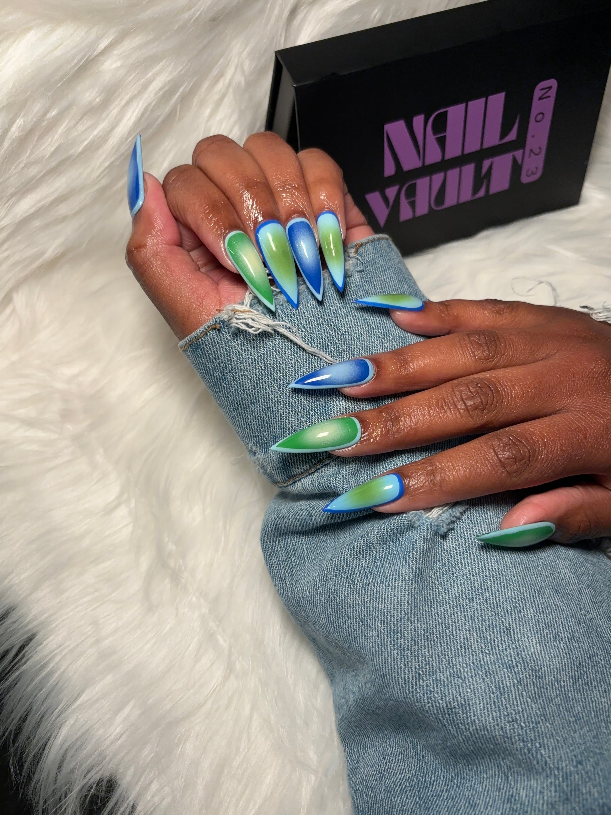 Aura airbrush press-on nails featuring a seamless gradient blend of green, sky blue, and light green tones. Designed for a soft, modern aesthetic with a high-gloss finish. Hand-painted on 100% Gel X tips for a salon-quality, reusable finish. Available in Square, Stiletto, Ballerina, and Coffin shapes