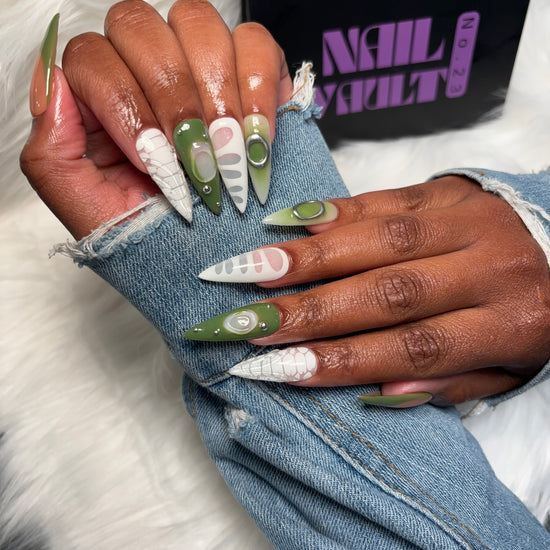 Green & White French Tip Press-On Nails with blooming gel crocodile design, silver studs, isolated chrome charms, and 3D jelly accents. Available in Square, Stiletto, Ballerina, and Coffin shapes. Handmade, 100% Gel X, reusable, and salon-quality