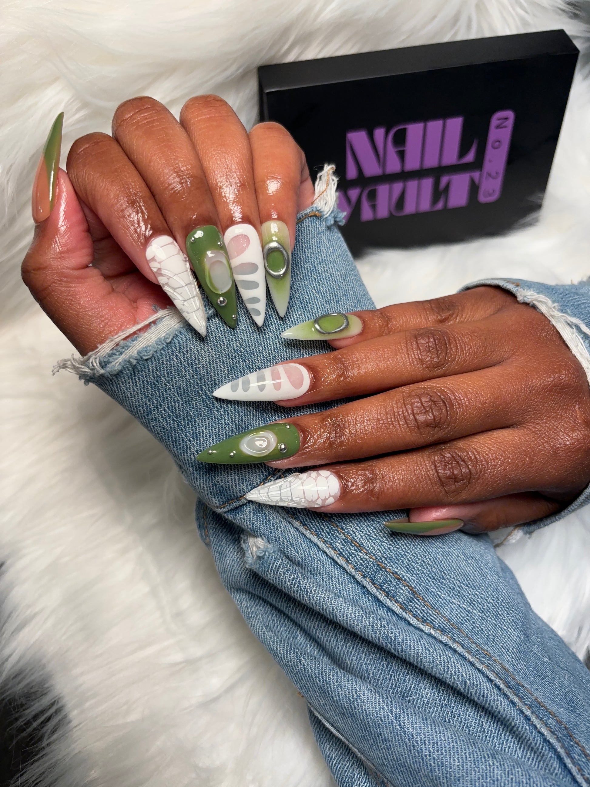 Green & White French Tip Press-On Nails with blooming gel crocodile design, silver studs, isolated chrome charms, and 3D jelly accents. Available in Square, Stiletto, Ballerina, and Coffin shapes. Handmade, 100% Gel X, reusable, and salon-quality