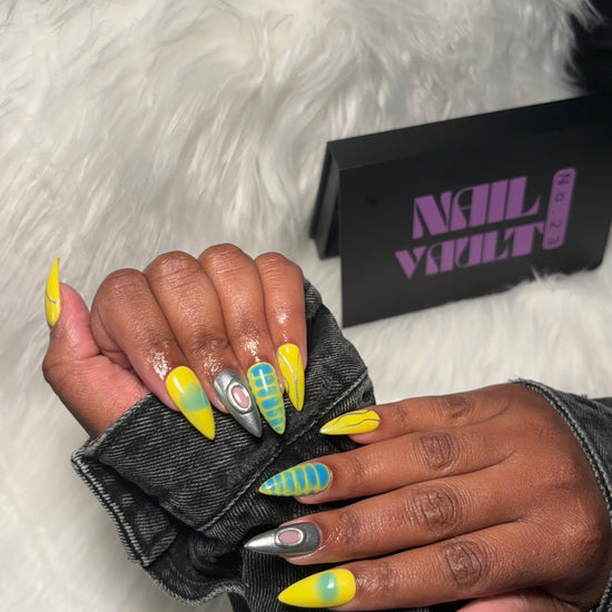 yellow and blue aura airbrush press-on nails featuring silver chrome accents, abstract line art, blooming gel blue crocodile texture, and isolated chrome charms.