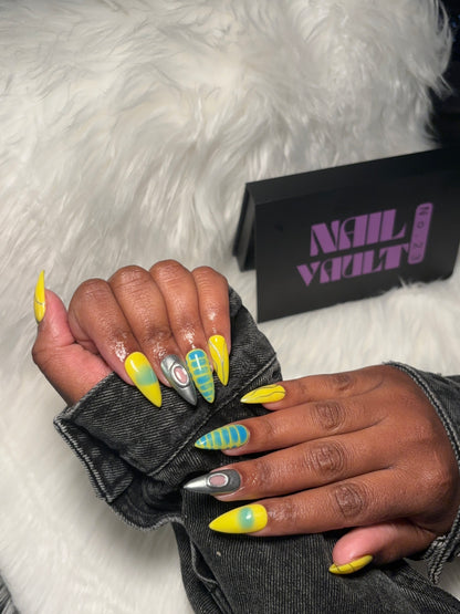 yellow and blue aura airbrush press-on nails featuring silver chrome accents, abstract line art, blooming gel blue crocodile texture, and isolated chrome charms.